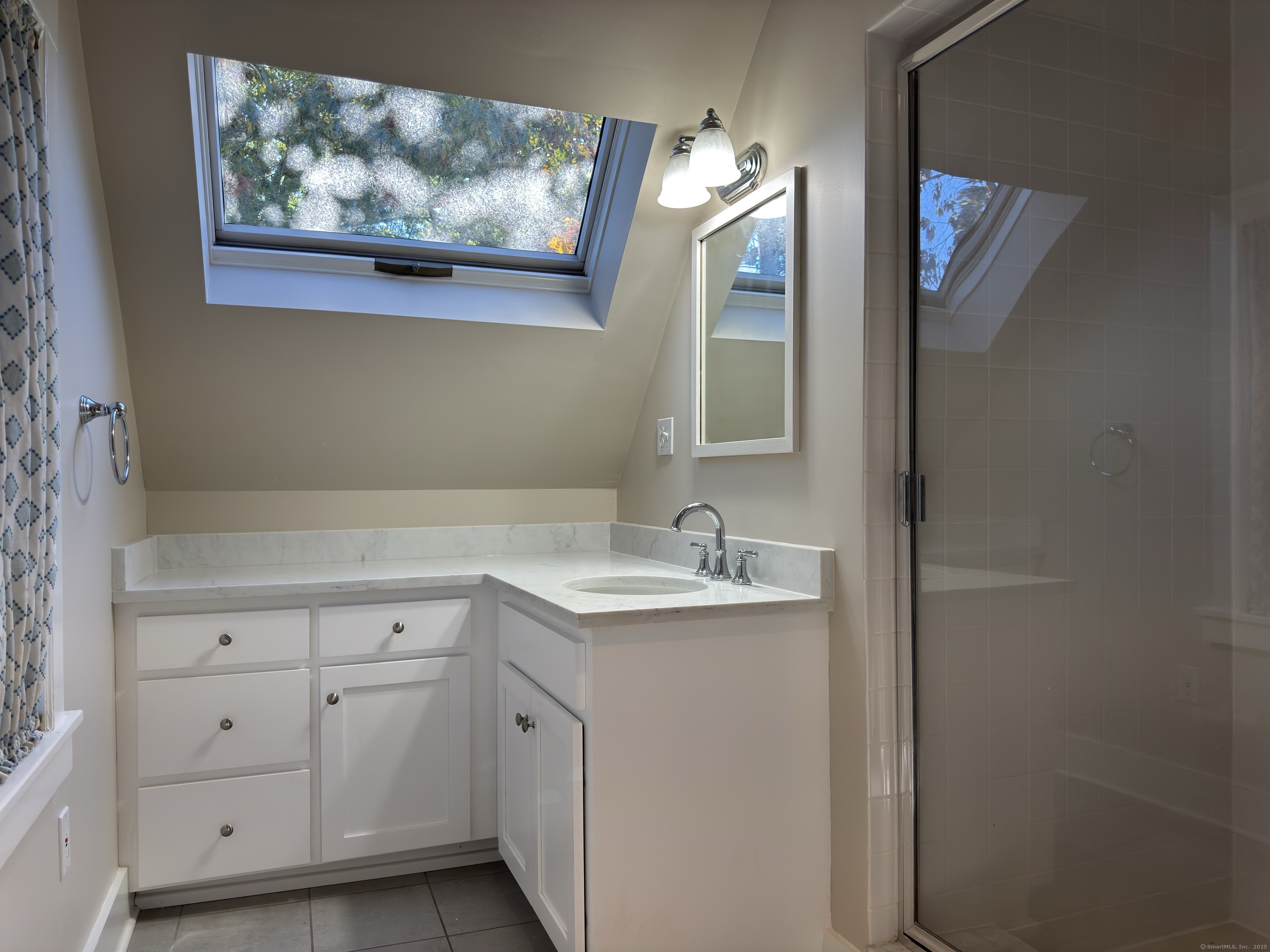 4 Sycamore Lane West Hartford, CT 06117 - Photo 12 of 19 a bathroom with a sink and a mirror