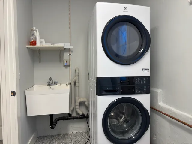a utility room with sink dryer and washer