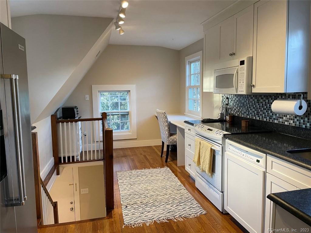 4 Sycamore Lane West Hartford, CT 06117 - Photo 5 of 19 a kitchen with stainless steel appliances granite countertop a refrigerator a stove and a wooden floors