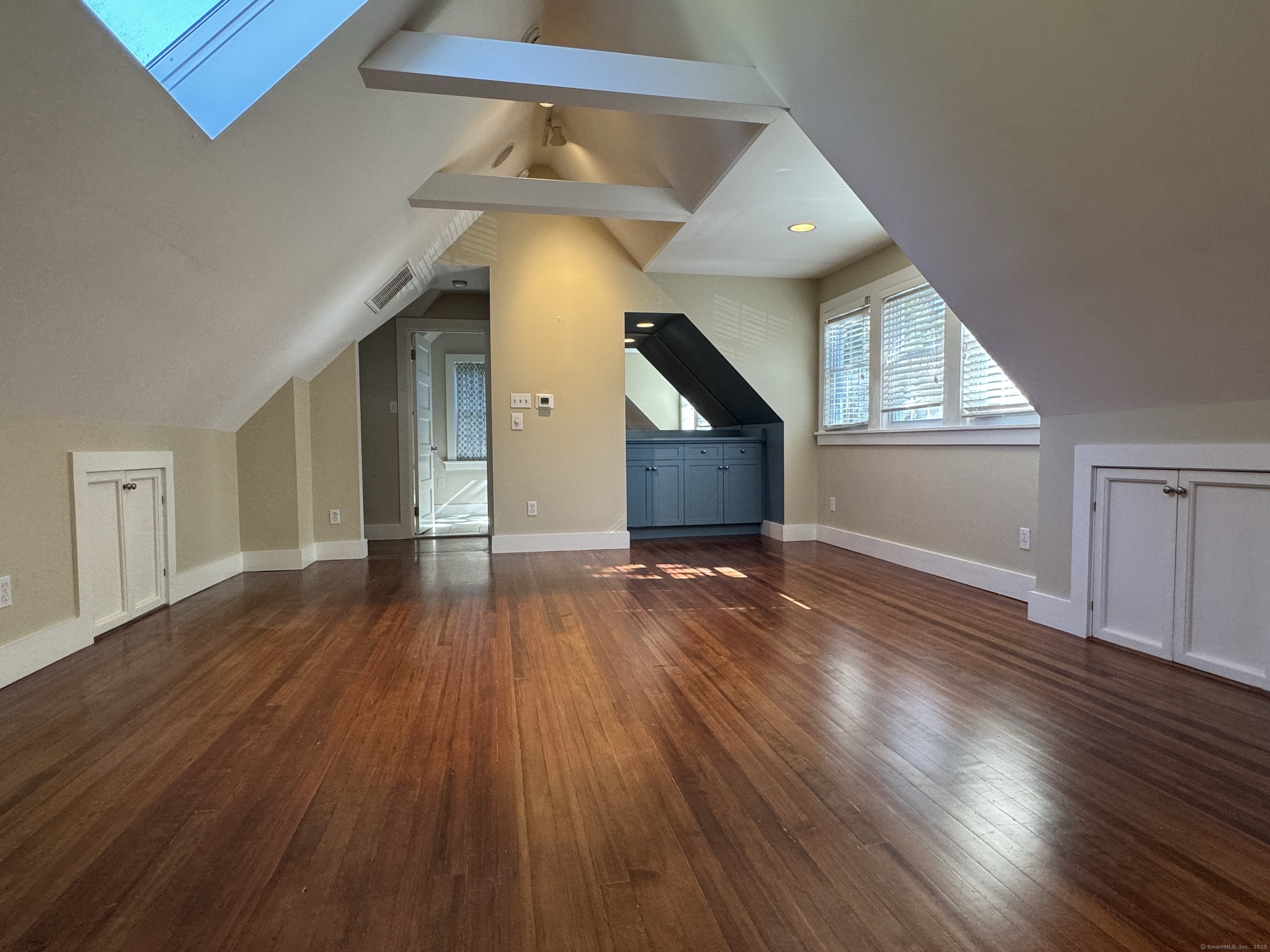 4 Sycamore Lane West Hartford, CT 06117 - Photo 9 of 19 a view of empty room with wooden floor and fan