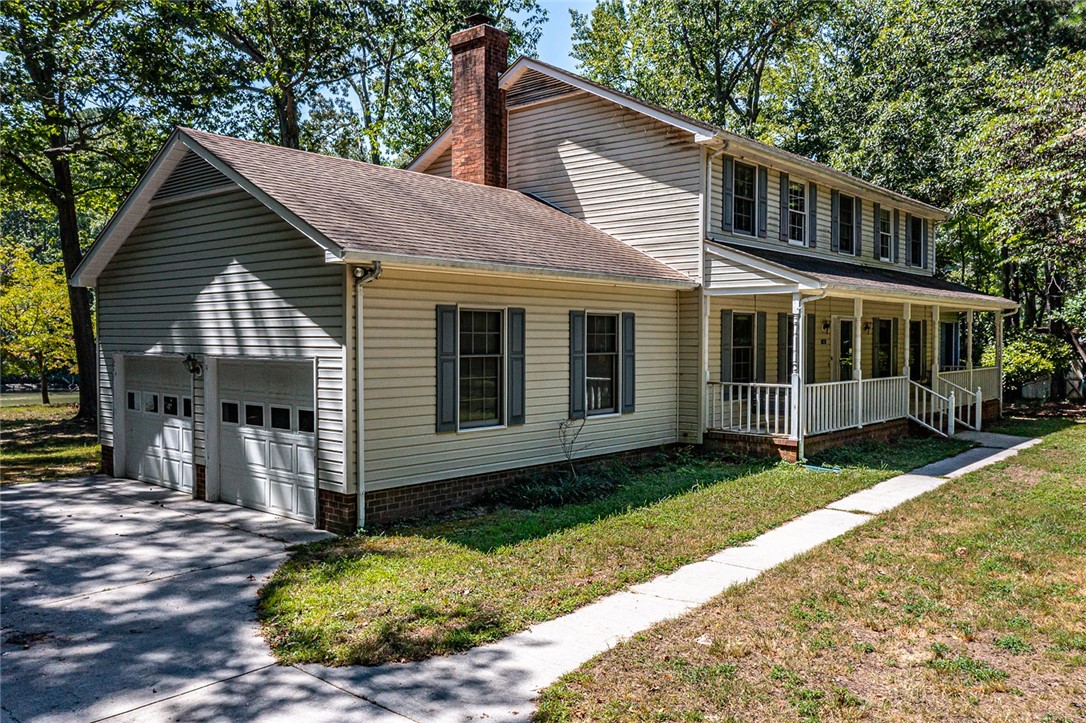 148 Denver Road Heathsville, VA 22473 - Photo 2 of 50 View of front of house featuring a porch, a chimney, a shingled roof, and a front lawn