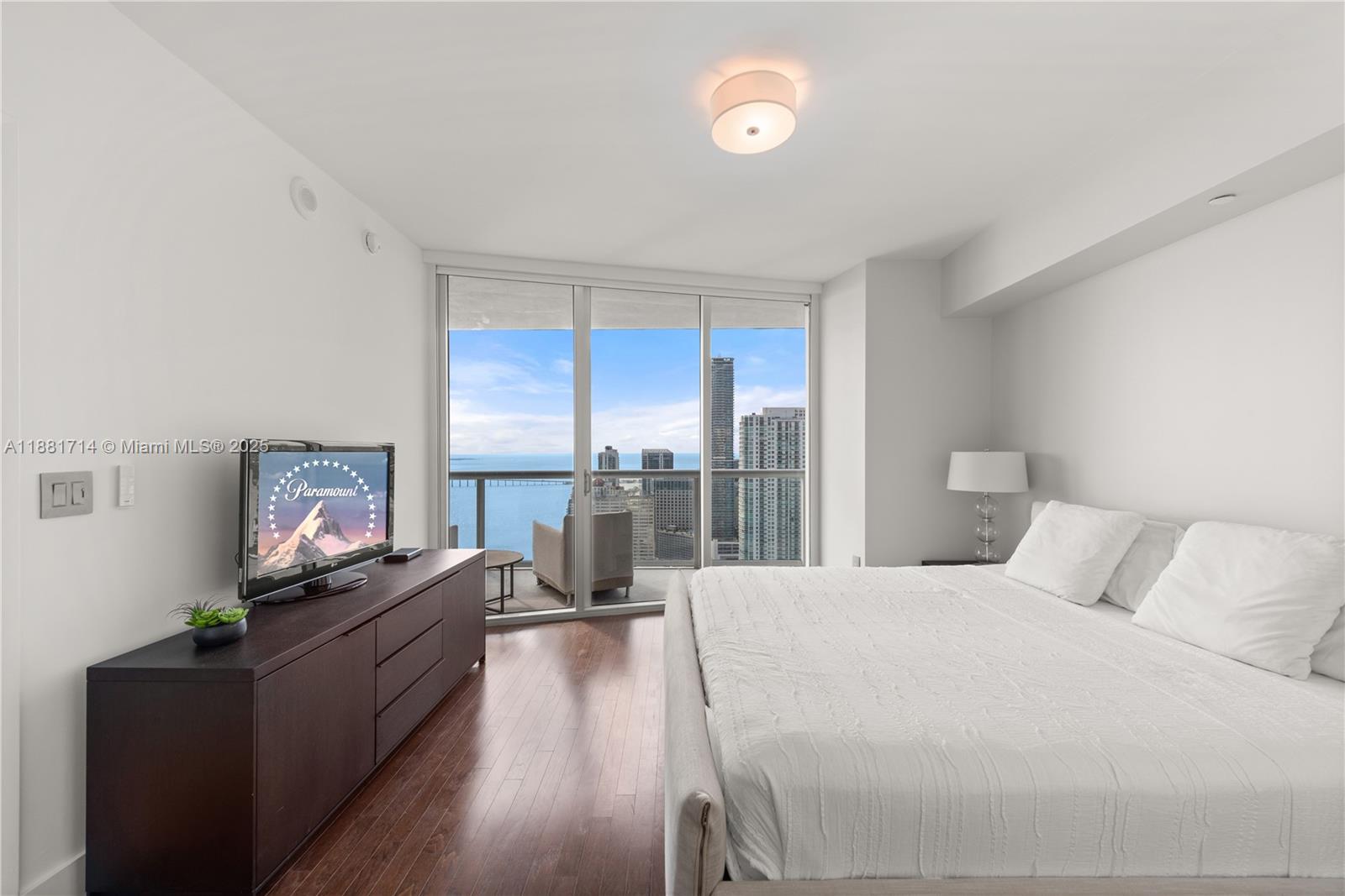 495 Brickell Avenue, Unit 5003 Miami, FL 33131 - Photo 11 of 21 a living room with furniture fireplace and flat screen tv