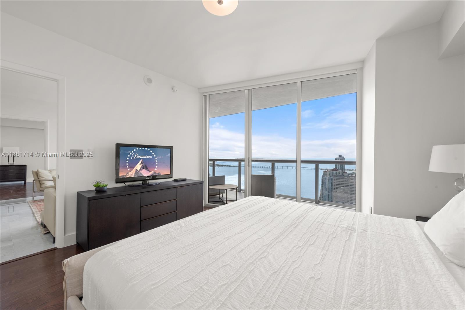 495 Brickell Avenue, Unit 5003 Miami, FL 33131 - Photo 12 of 21 a large bedroom with a bed and a flat screen tv