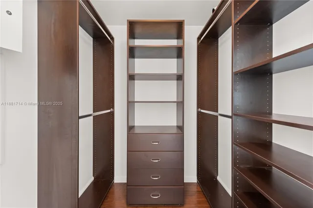 a view of walk in closet with empty racks
