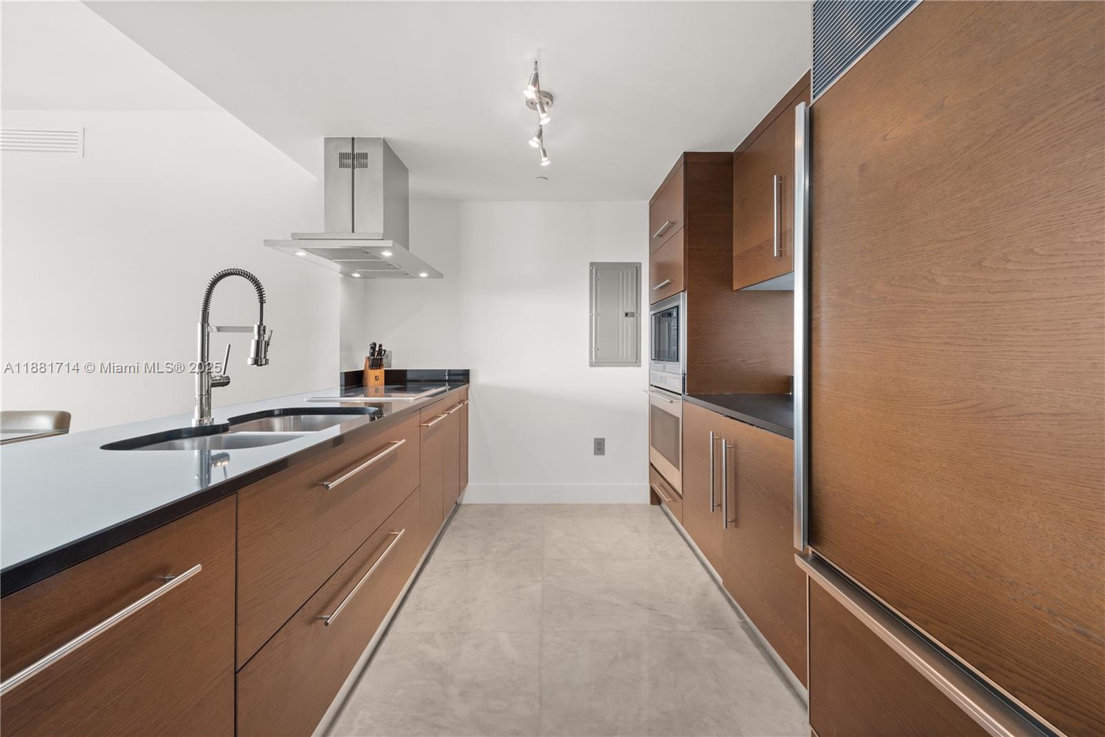 495 Brickell Avenue, Unit 5003 Miami, FL 33131 - Photo 4 of 21 a large kitchen with cabinets and stainless steel appliances