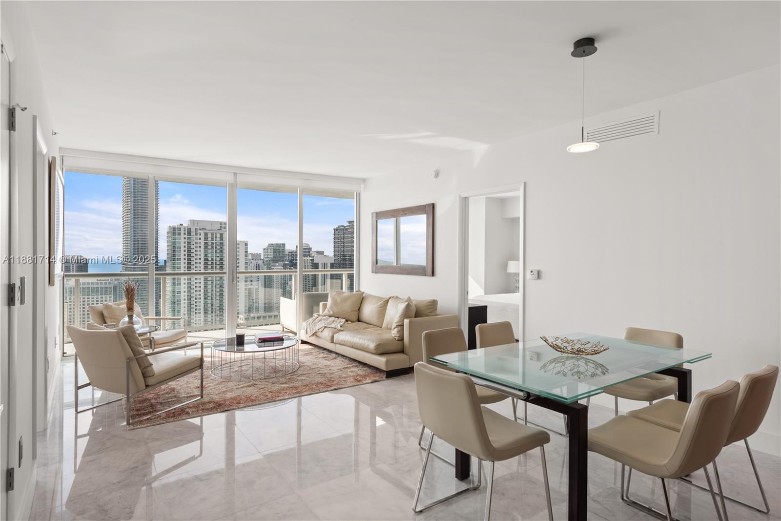 495 Brickell Avenue, Unit 5003 Miami, FL 33131 - Photo 6 of 21 a living room with furniture and a floor to ceiling window