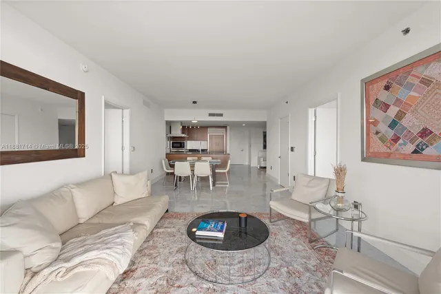 a living room with furniture and a rug