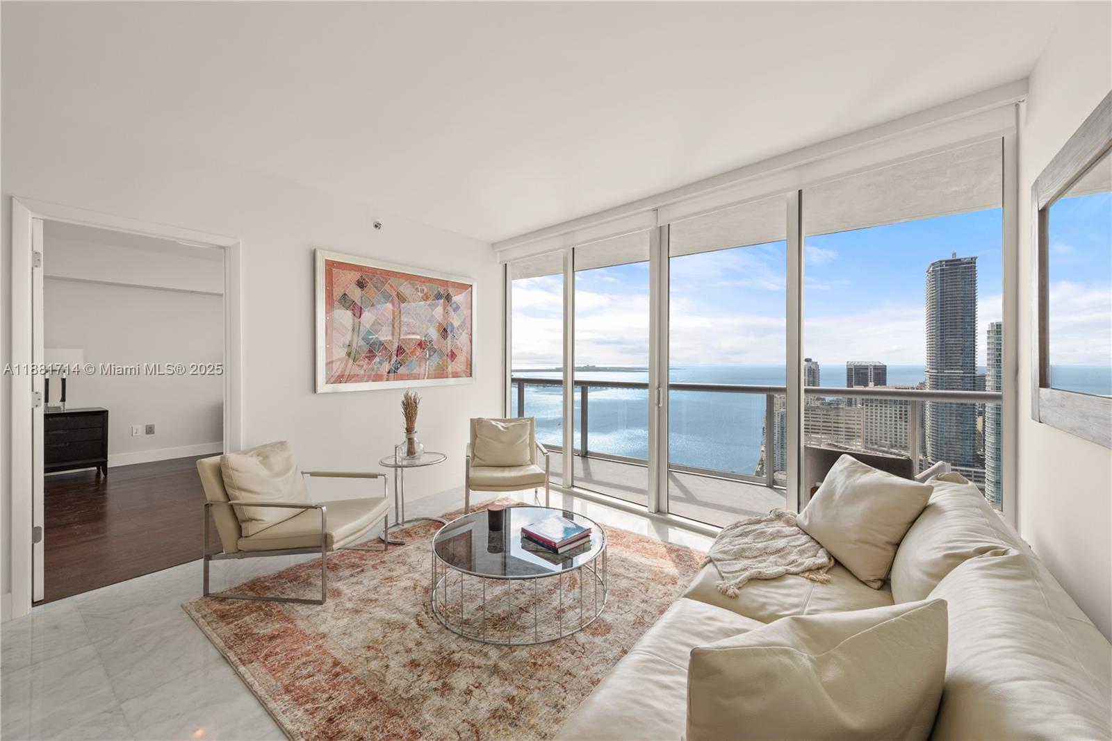 495 Brickell Avenue, Unit 5003 Miami, FL 33131 - Photo 8 of 21 a living room with furniture and a floor to ceiling window