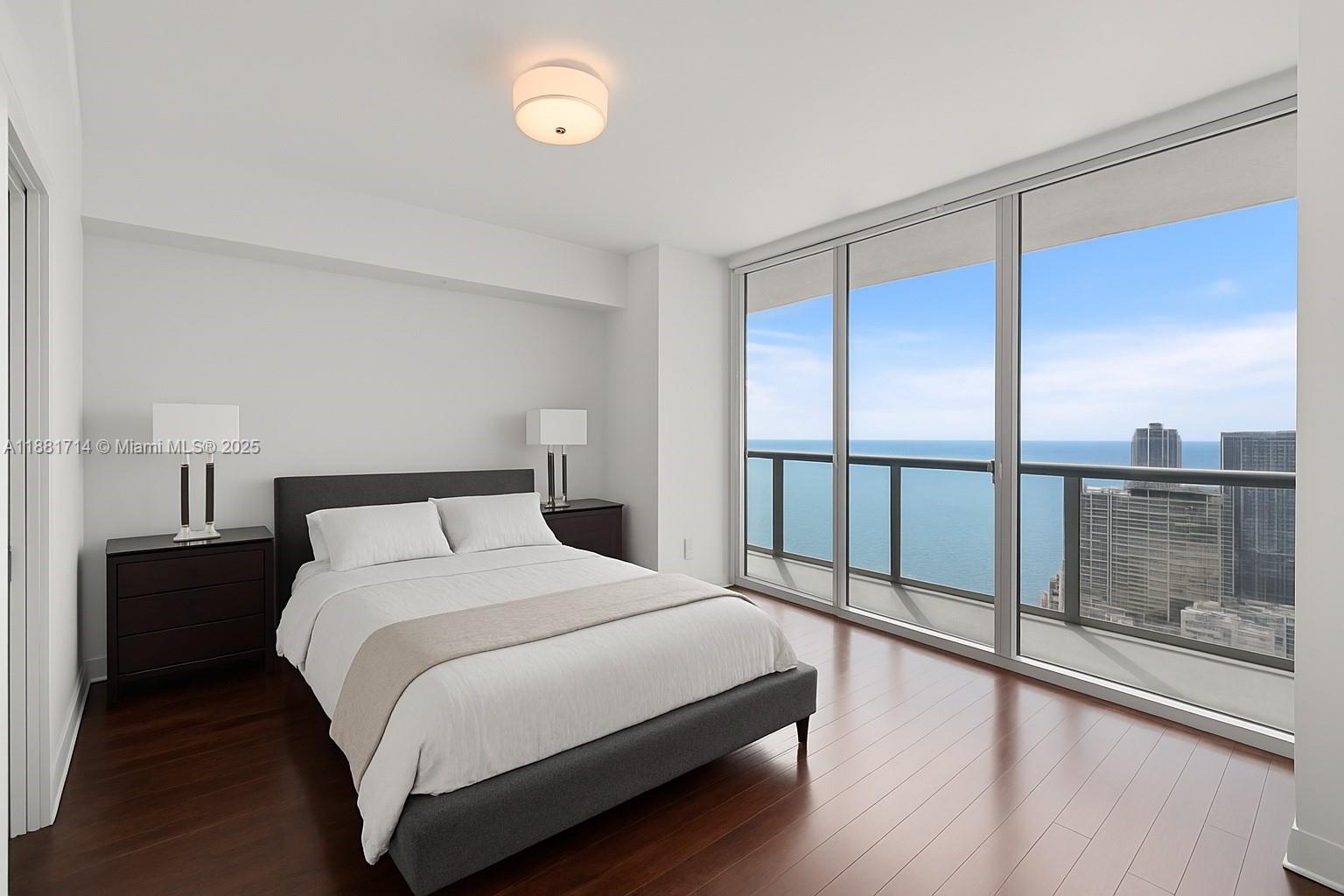 495 Brickell Avenue, Unit 5003 Miami, FL 33131 - Photo 9 of 21 a bedroom with a large bed and a window