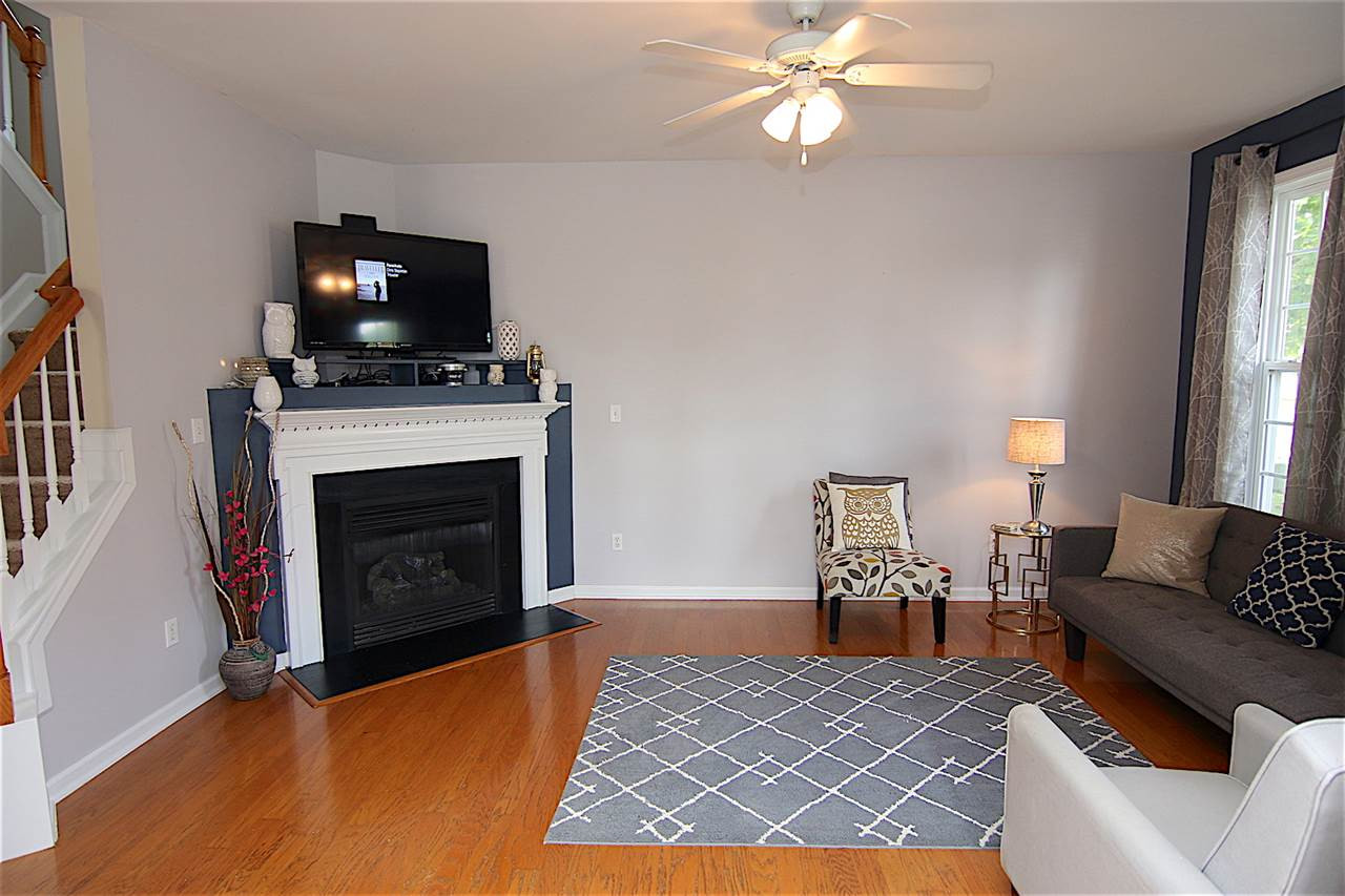 15 Scotch Bonnet Ridge Clayton, NC 27520 - Photo 7 of 25 Family Room with Accent Walls and Gas Log Fireplace Family Room