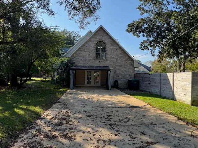 a front view of a house with yard and trees