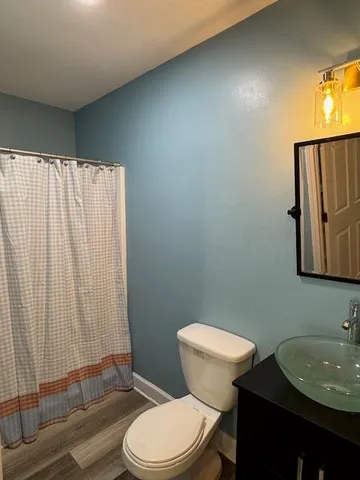 a bathroom with a toilet a sink and a mirror