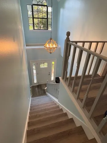 a view of entryway and hall with wooden floor