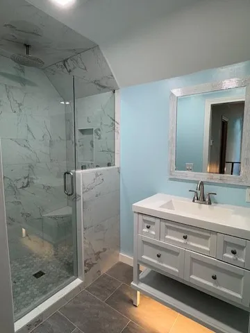 a bathroom with a sink a shower and a mirror