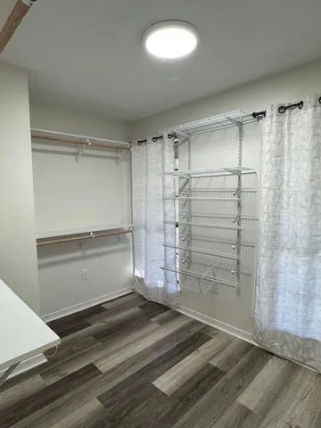 a view of walk in closet with empty racks