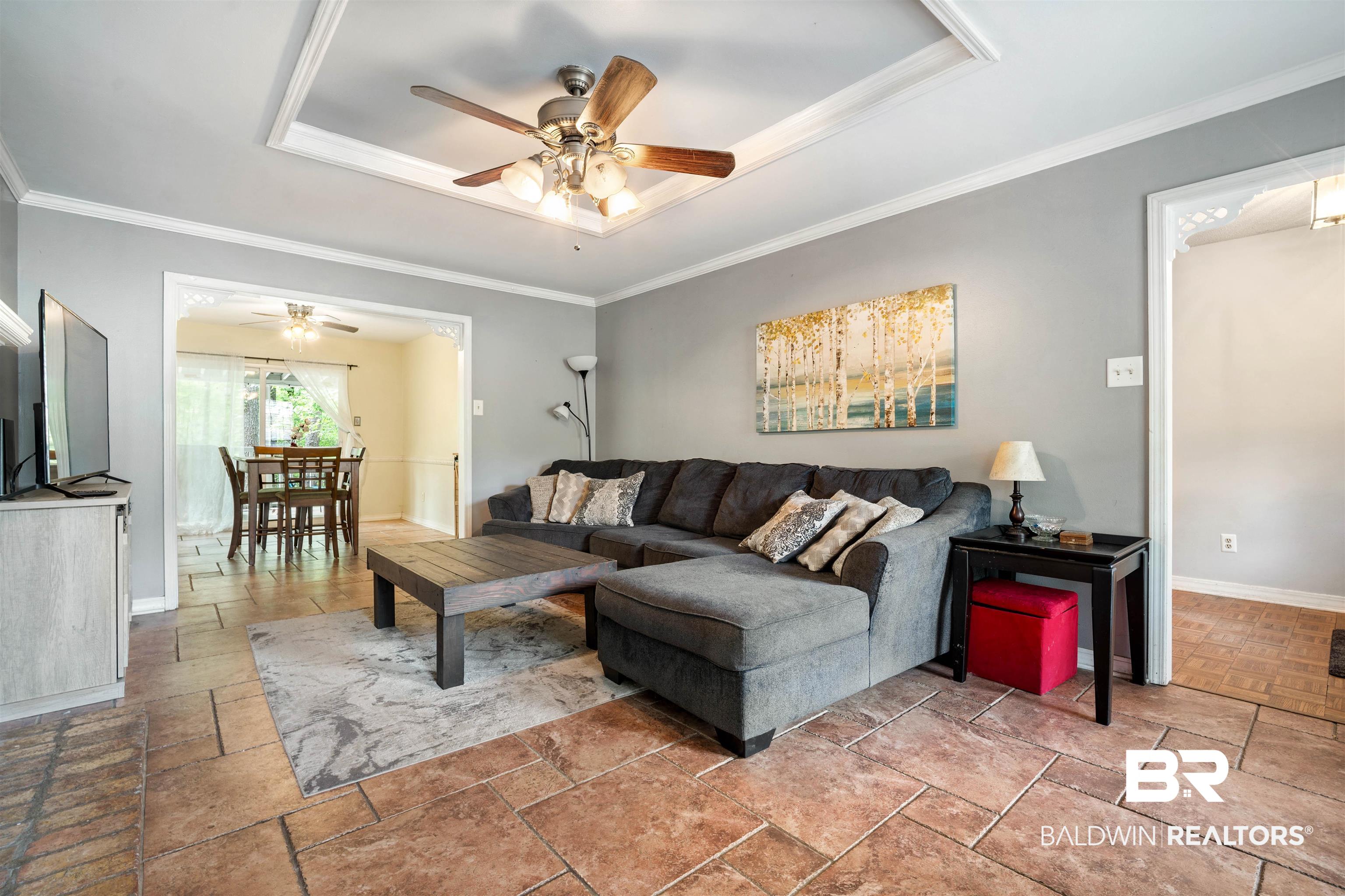 2823 Woodland Road Mobile, AL 36693 - Photo 3 of 29 Living area with a raised ceiling, crown molding, baseboards, and ceiling fan