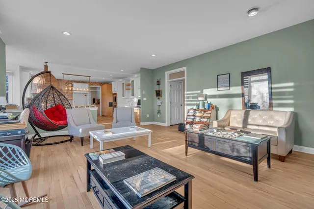 a living room with furniture a rug and a piano