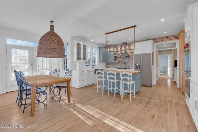 a dining room with furniture and wooden floor