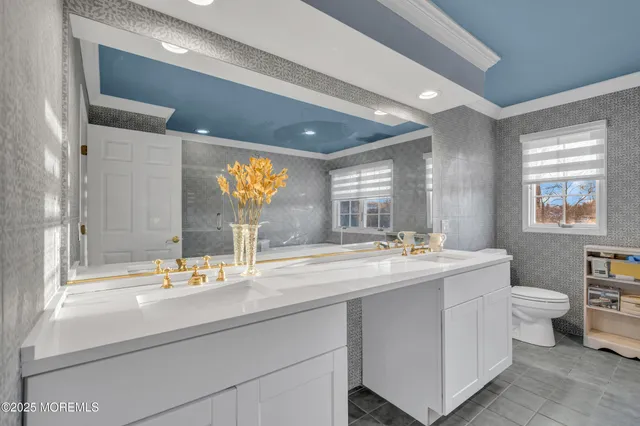 a living room with furniture a couch and dresser with wooden floor