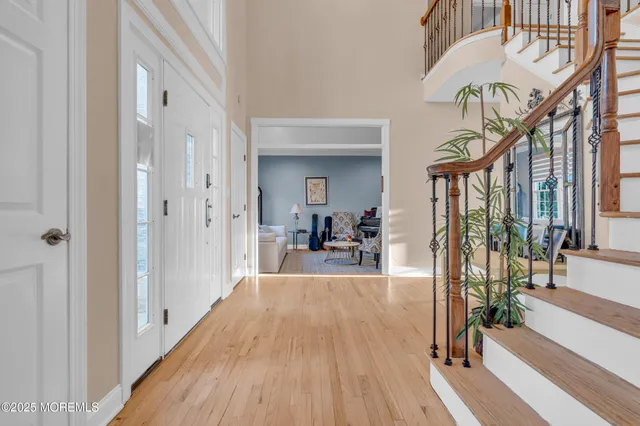 a view of a hallway view with wooden floor and staircase