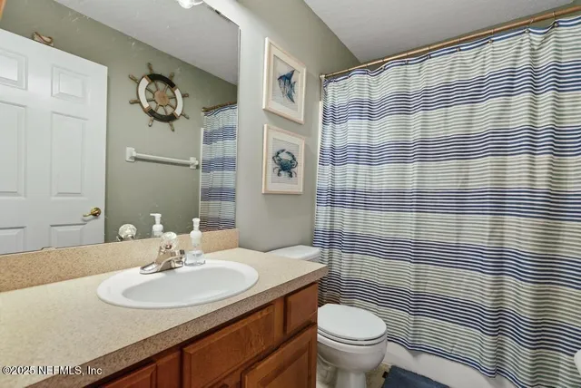 a kitchen with stainless steel appliances granite countertop a refrigerator a stove and a sink