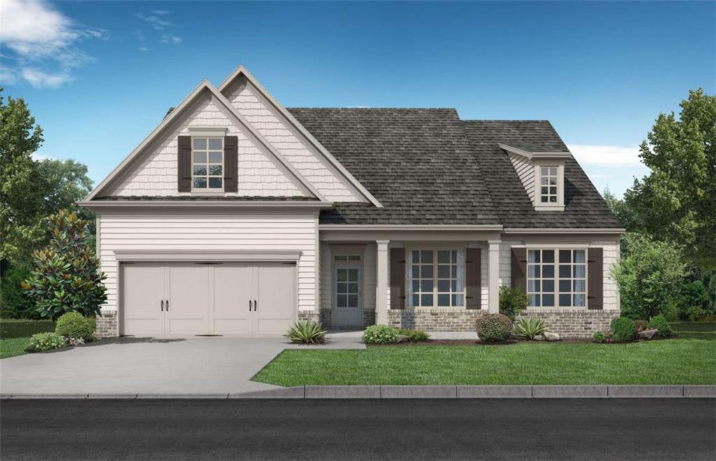 a front view of a house with a garden and garage