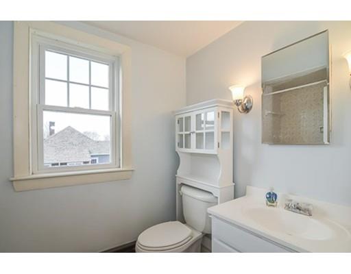 9 Merrill Road Watertown, MA 02472 - Photo 12 of 14 a bathroom with a sink mirror toilet and next to a window