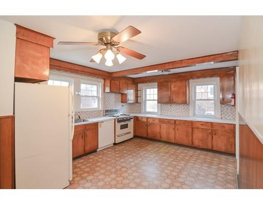 9 Merrill Road Watertown, MA 02472 - Photo 5 of 14 a kitchen with stainless steel appliances kitchen island granite countertop a stove a sink and a refrigerator