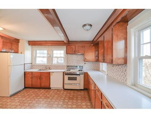 9 Merrill Road Watertown, MA 02472 - Photo 6 of 14 a kitchen with stainless steel appliances granite countertop a stove a sink and a refrigerator
