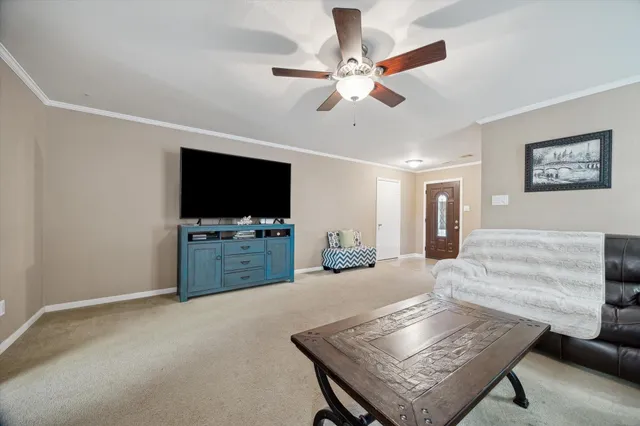 a living room with furniture and a flat screen tv