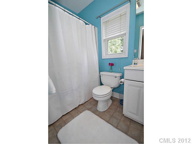 4331 Applegate Road Charlotte, NC 28209 - Photo 11 of 16 a bathroom with a toilet and a shower curtain