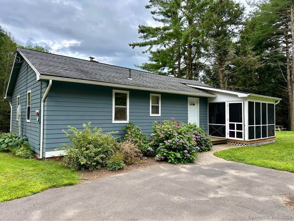 a front view of a house with a garden