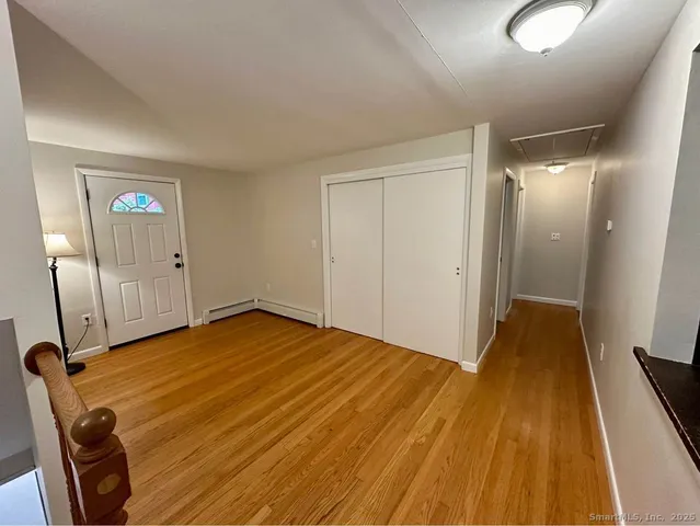 a view of a room with wooden floor