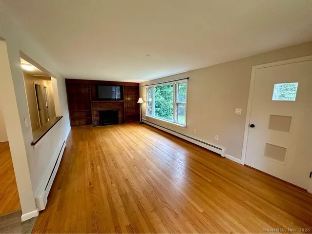 a view of a kitchen with wooden floor and stairs