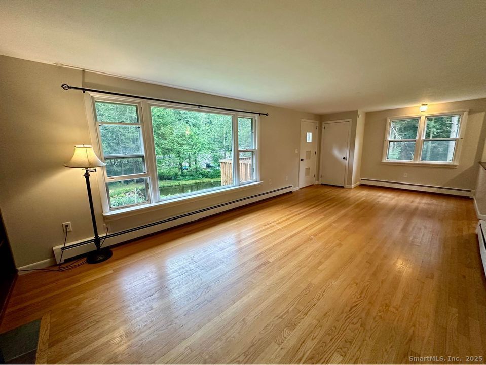 386 Cherry Brook Road Canton, CT 06019 - Photo 5 of 16 a view of a room with wooden floor and window