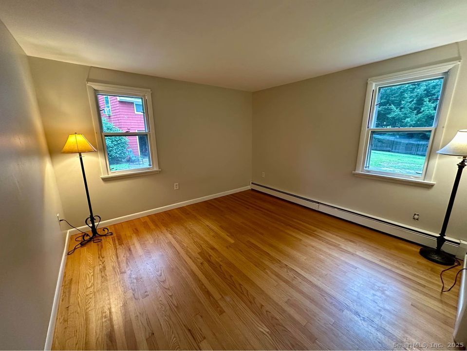 386 Cherry Brook Road Canton, CT 06019 - Photo 10 of 16 a view of a room with wooden floor mirror and windows