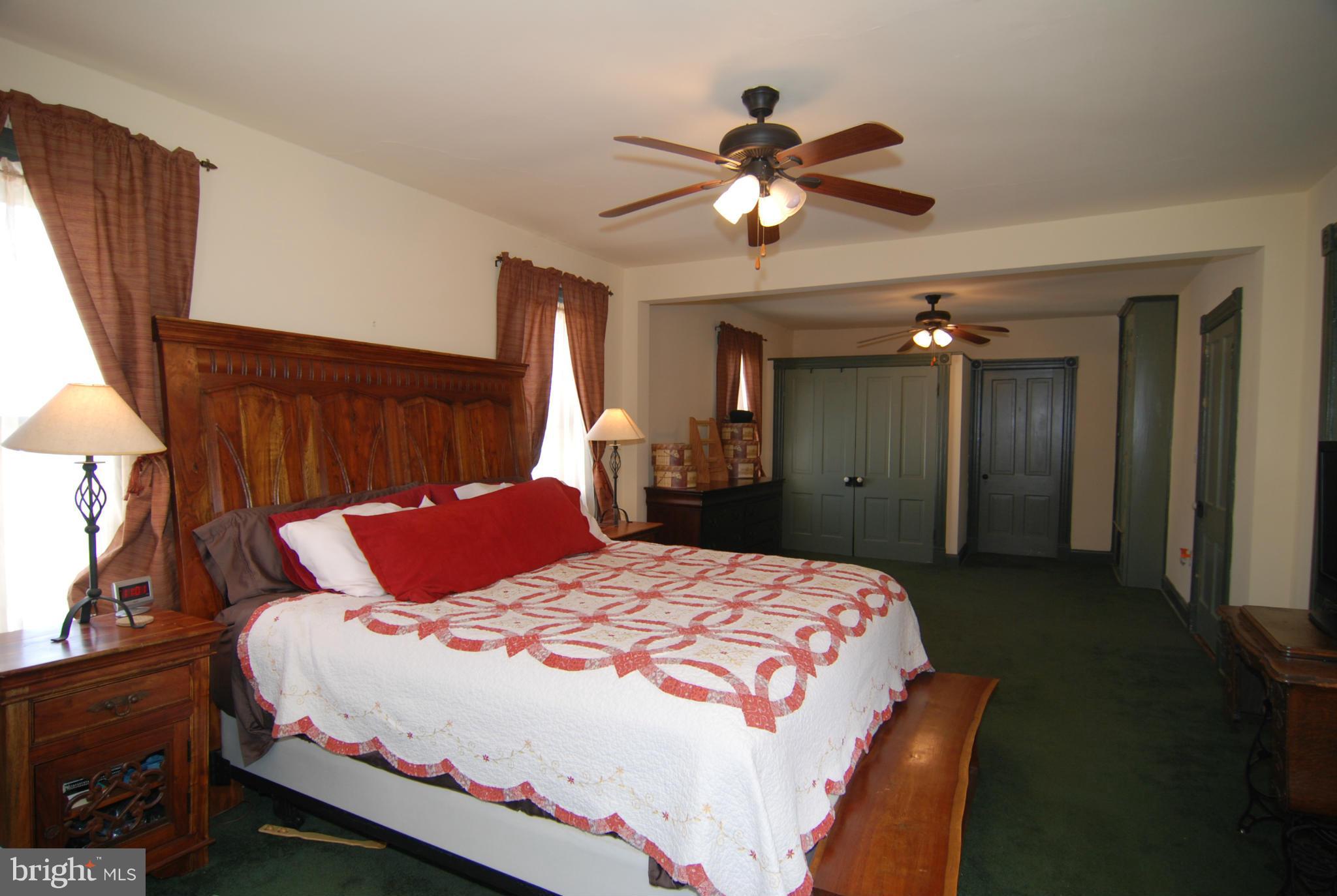 4256 Main Street Rohrersville, MD 21779 - Photo 14 of 26 a bedroom with a bed and a chandelier