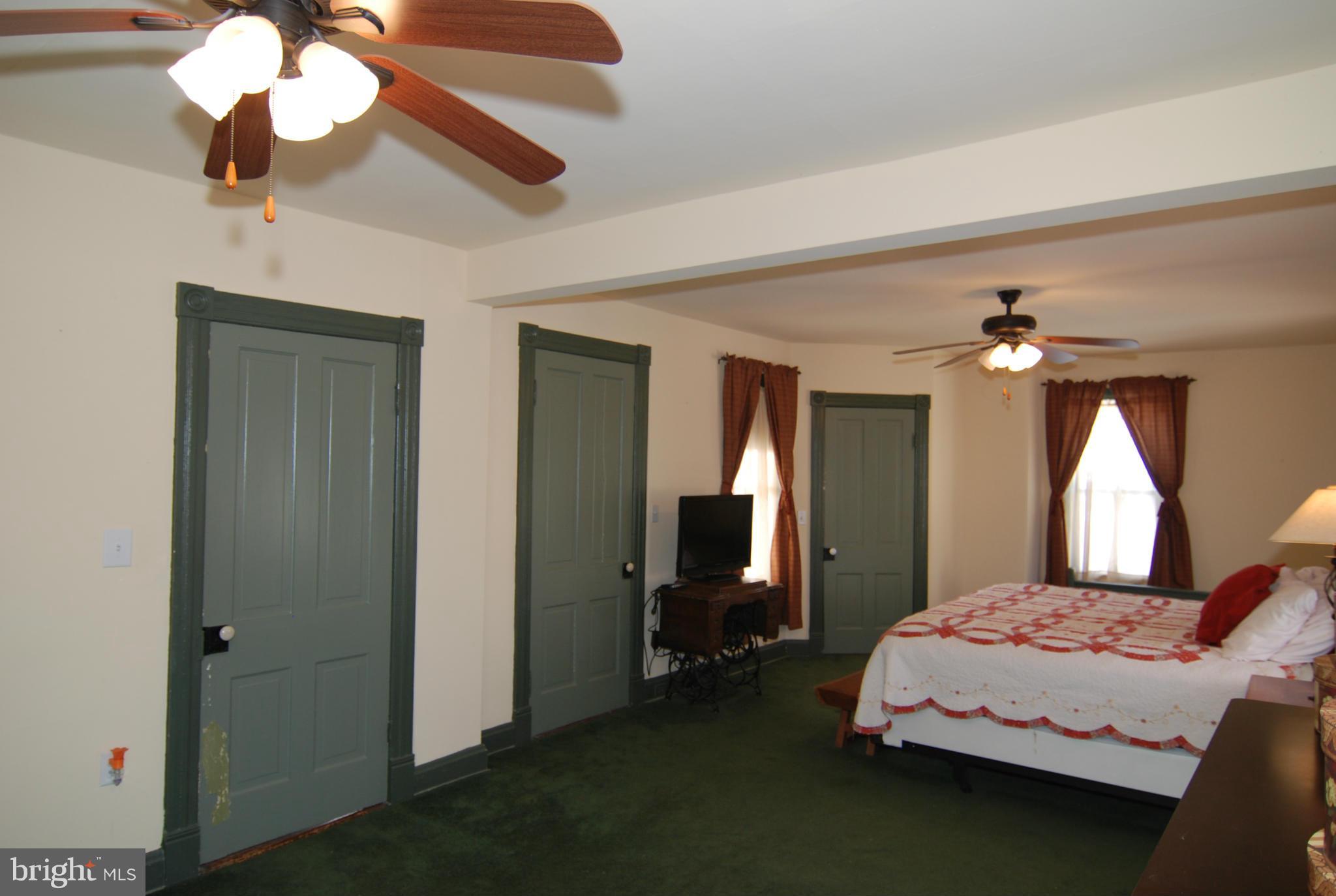4256 Main Street Rohrersville, MD 21779 - Photo 15 of 26 a bedroom with a bed chandelier and a window