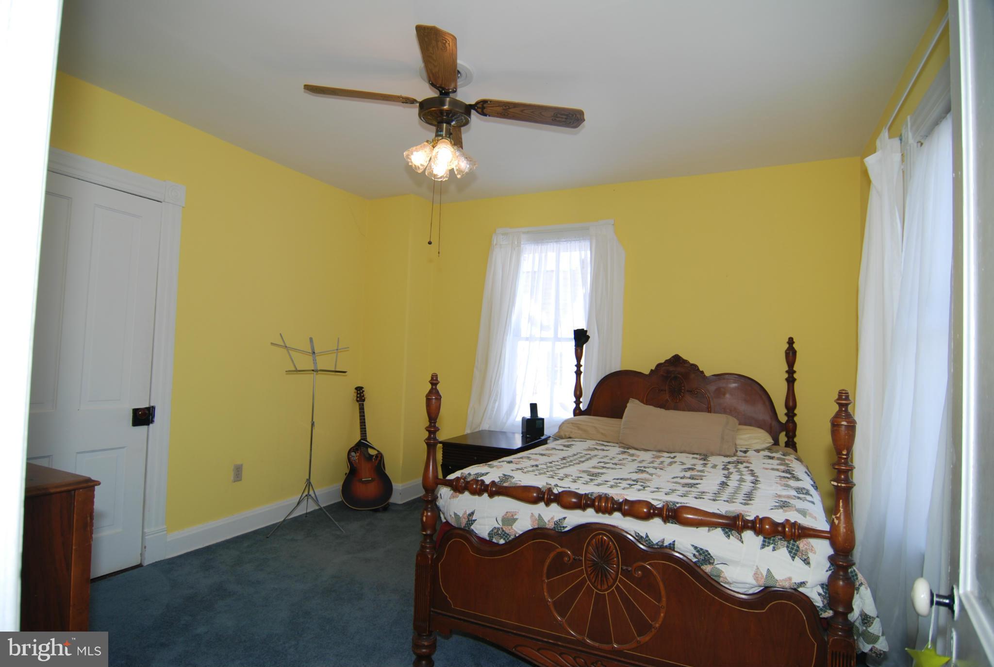 4256 Main Street Rohrersville, MD 21779 - Photo 22 of 26 a bedroom with a bed and a chandelier
