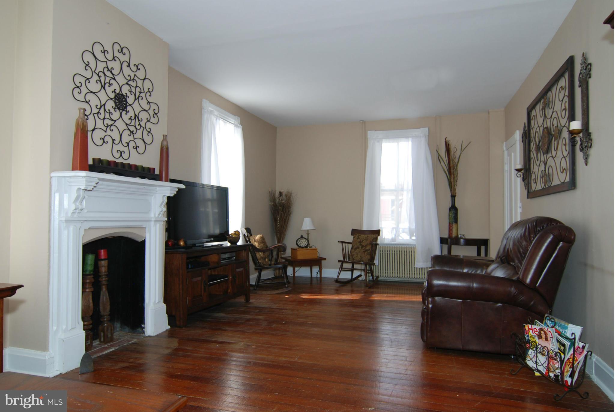 4256 Main Street Rohrersville, MD 21779 - Photo 10 of 26 a living room with furniture or wooden floor and a fireplace