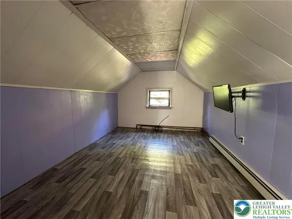 a view of wooden floor and windows in a room