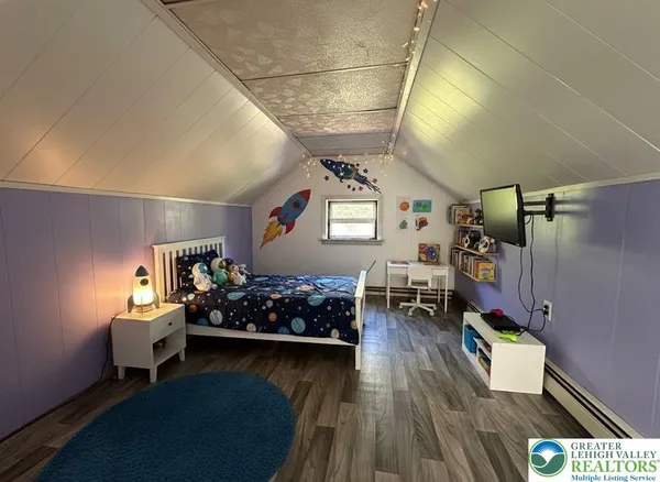 a bedroom with furniture and a wooden floor