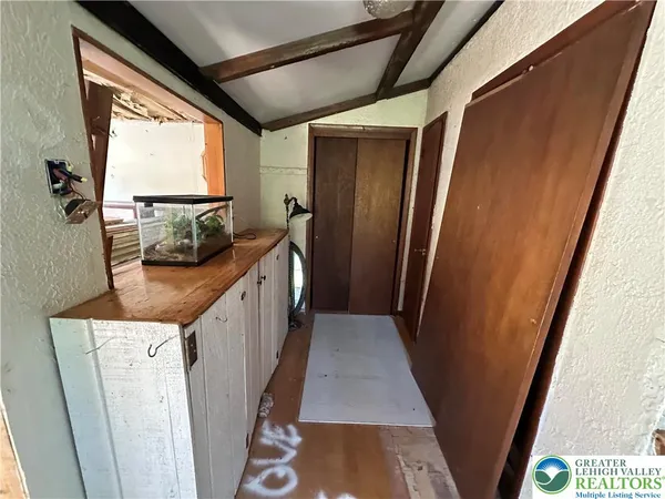 a view of a kitchen with fridge and wooden floor