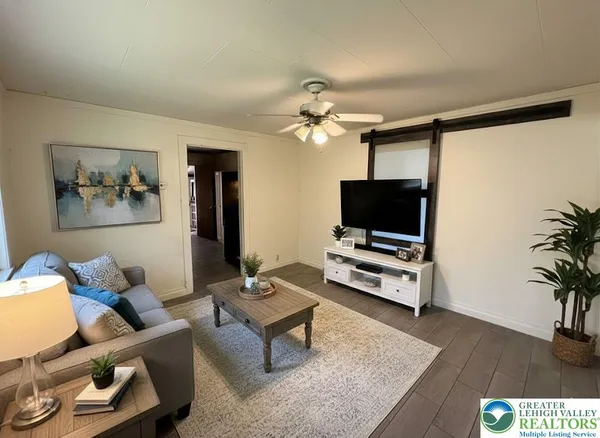 a living room with furniture and a flat screen tv