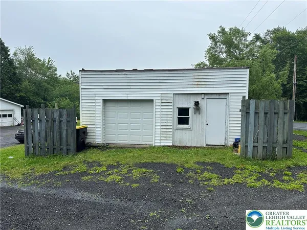 a view of a house with a yard and garage