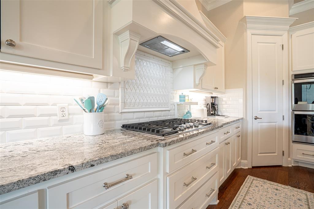 1920 Meander Road Granbury, TX 76049 - Photo 11 of 40 Kitchen featuring a built-in gas range, stainless steel double ovens, white shaker cabinetry, and stone countertops