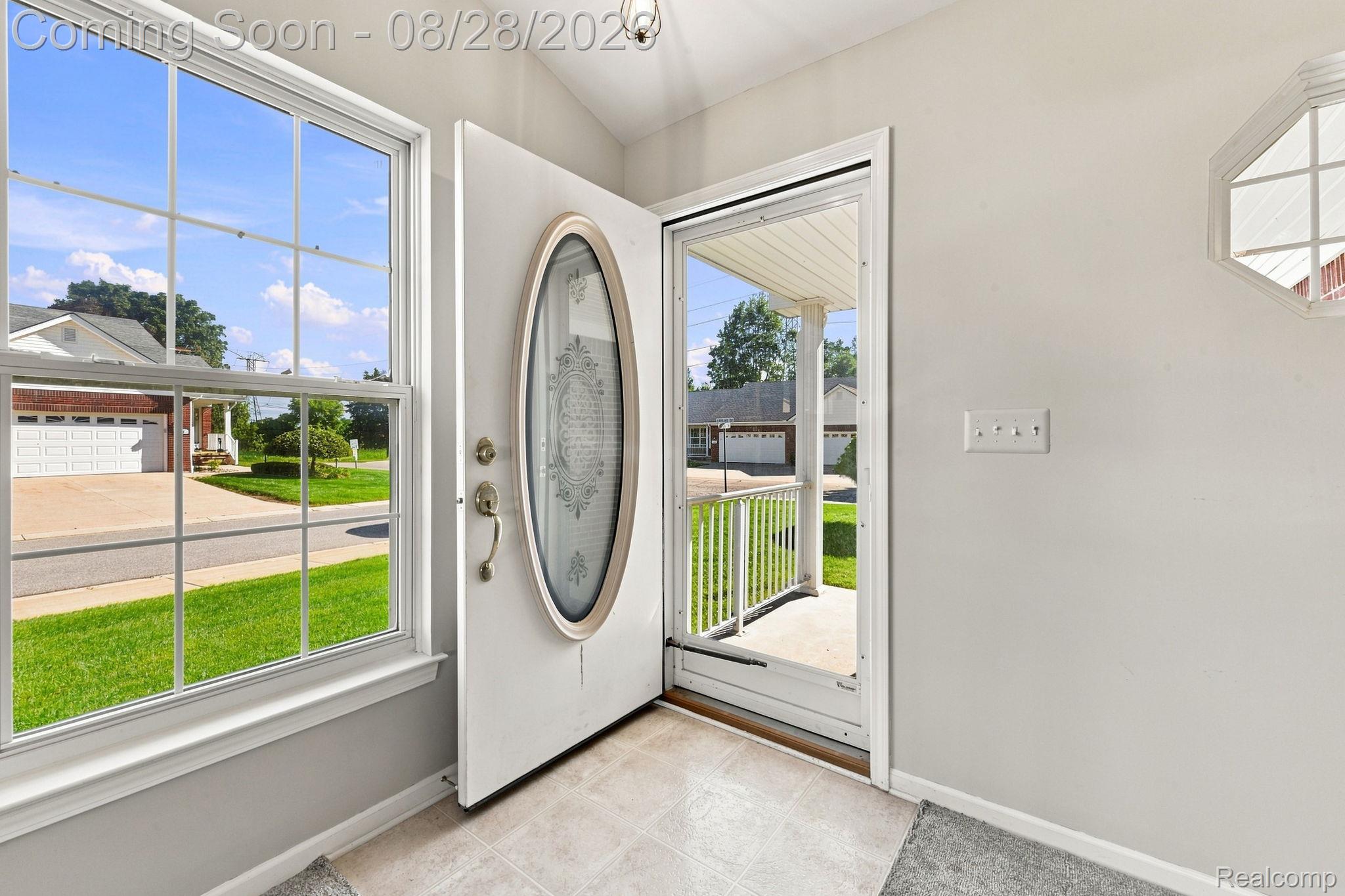 493 Harvard Drive Romeo, MI 48065 - Photo 6 of 36 Entryway featuring a decorative oval-lite door, transom window, and tiled flooring