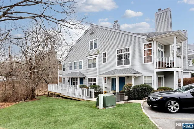 a view of a yard with a house and a tree