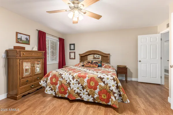 a bedroom with a bed and wooden floor