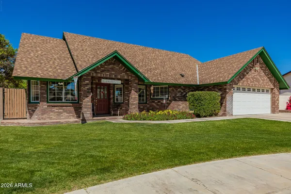 a front view of a house with a garden and yard